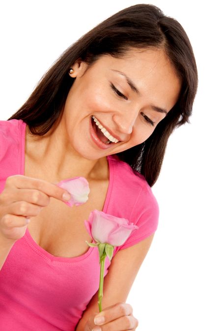 Woman with a flower thinking he loves me, he loves me not - isolated