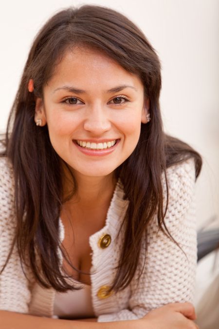 Happy woman lying on the floor and smiling