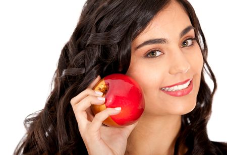 Beautiful woman holding an apple and smiling - isolated over white