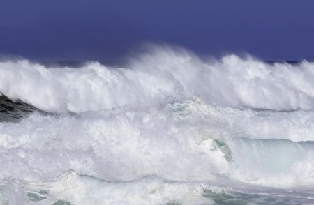 Breaking surf almost obliterates horizon of Pacific Ocean along North Shore of Oahu