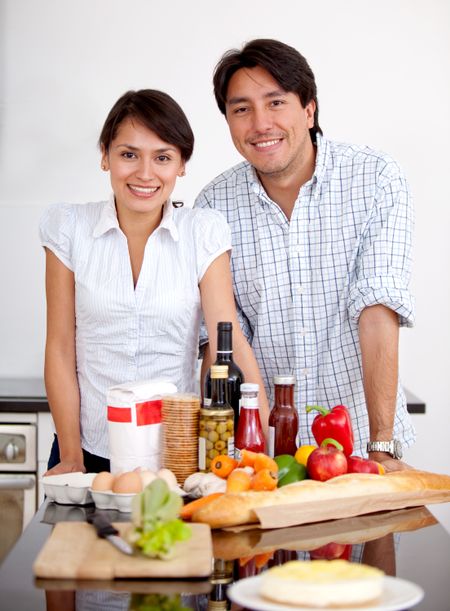 Couple in the kitchen cooking a romantic dinner