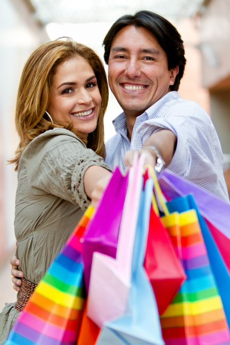 Beautiful shopping couple smiling and looking happy