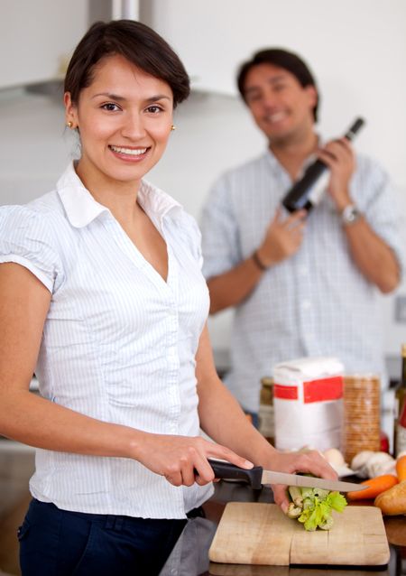Loving couple making dinner at home and smiling
