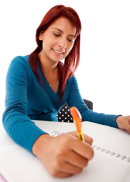 Female student writing on a notebook - isolated over white