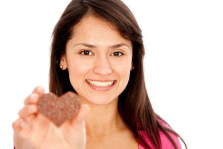 Happy woman holding a heart shaped chocolate - isolated