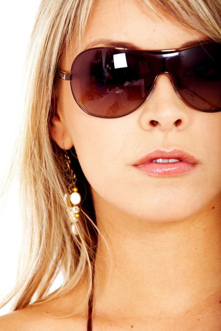 beautiful blond fashion woman wearing sunglasses over a white background