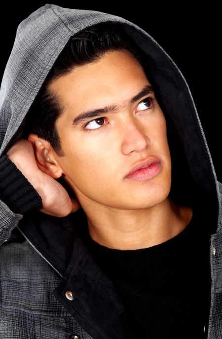 fashion man portrait with his hood up over a black background