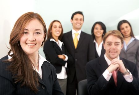Business team in an office with a businesswoman leading