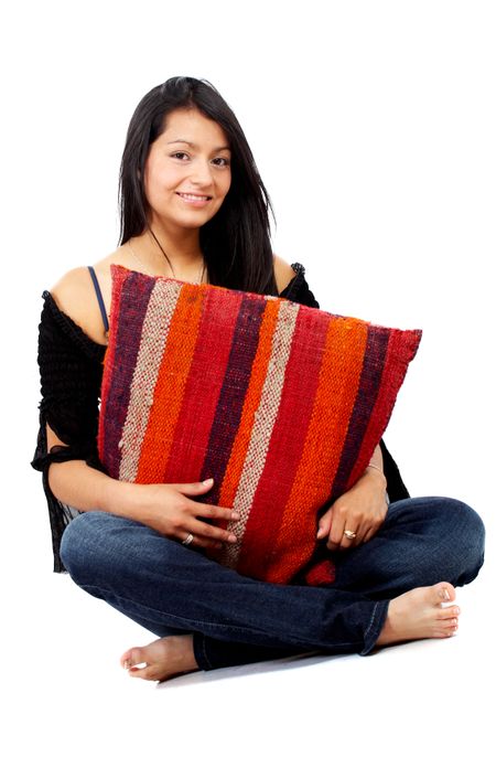 casual girl portrait holding a cushion isolated over a white background