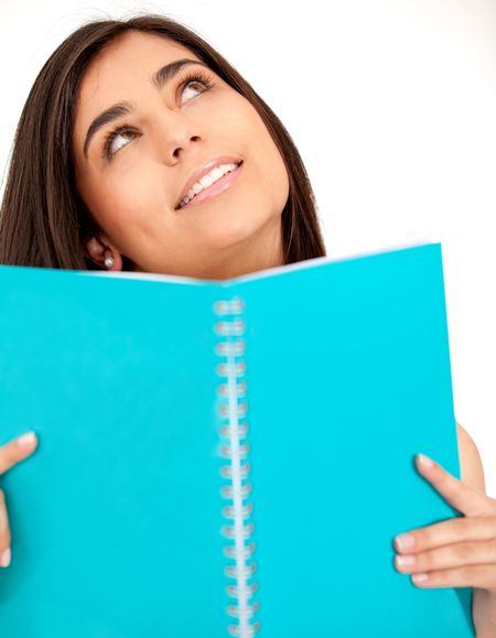 Pensive female student holding a notebook - isolated over white
