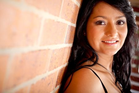 Gorgeous woman portrait over a brick wall