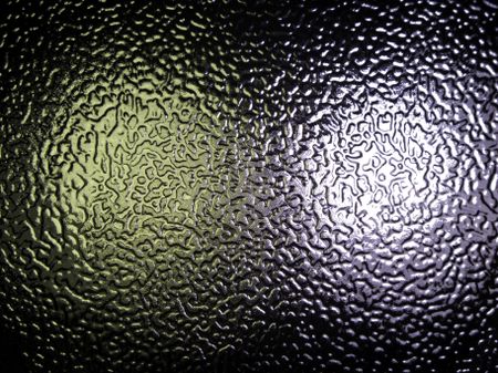 Pattern of opaque glass backlit by two different light bulbs