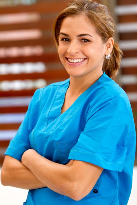 Friendly female doctor smiling at the hospital
