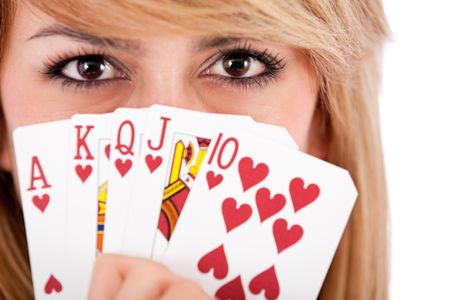 Female Poker player with a royal flush - isolated over white