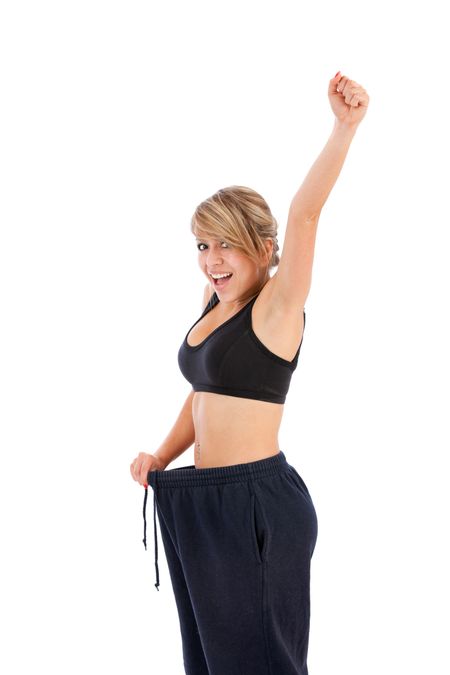 Happy woman with loose-fitting clothes - lose weight concepts