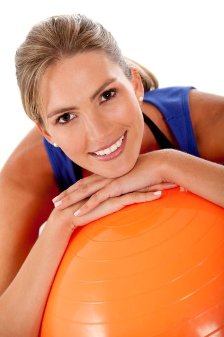 Sportive woman with a pilates ball - isolated over white