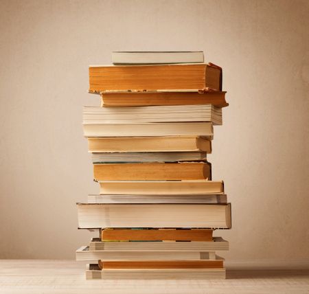 A stack of old books with vintage background