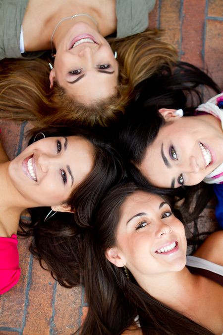 Group of women lying on the floor with heads together