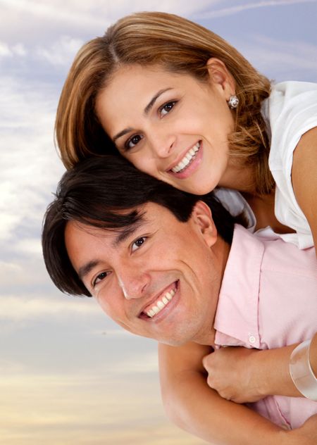 Beautiful loving couple hugging with the sky on the background