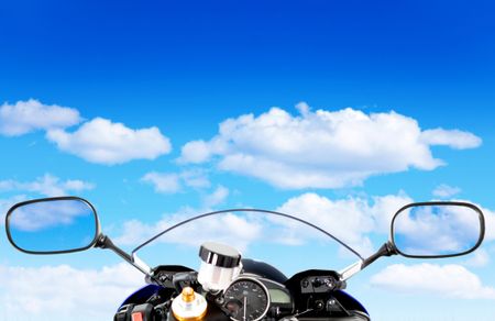 Motorcycle front with the view of a blue cloudy sky