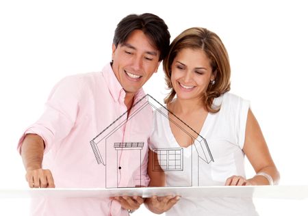 Couple with the mock-up of a house - isolated over a white background