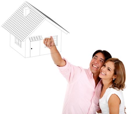 Couple pointing a house drawing - isolated over a white background
