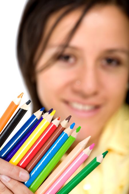 girl holding colour pencils smiling over white