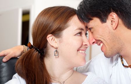 couple at home facing each other while smiling - lifestyle portrait