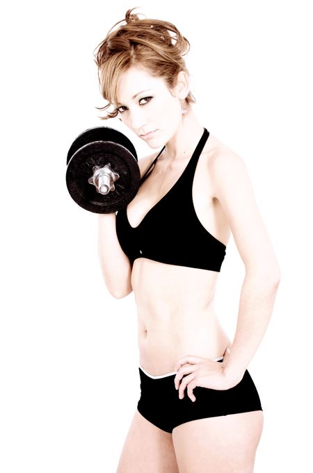 fashion girl in gym clothes lifting free weights isolated over a white background with a high key effect