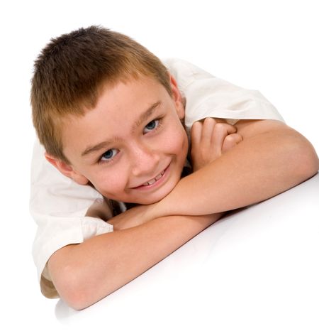 kid portrait smiling on the floor isolated over a white background