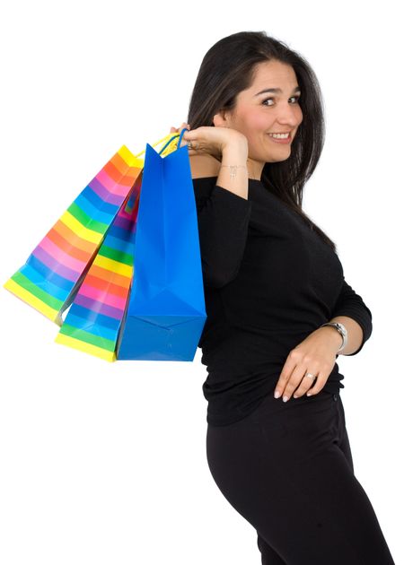 happy girl smiling holding shopping bags - isolated over a white background