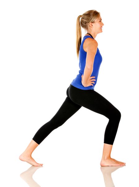 Sportive woman stretching - isolated over a white background