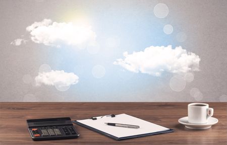 Close up of business office desk concept with clouds, blue sky and sunshine