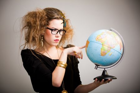 Crazy woman with messy hairdo holding a globe