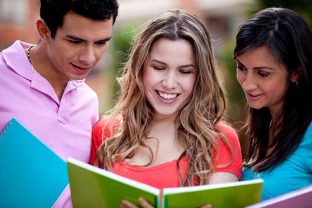 Group of students with a notebook outdoors