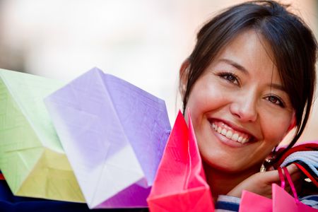 Beautiful shopping woman holding bags at a mall