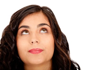 Beautiful thoughtful woman looking up - isolated over white