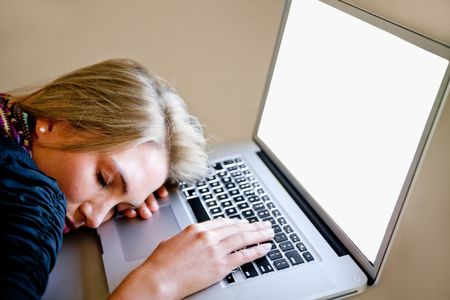 Tired woman sleeping over a laptop computer while working