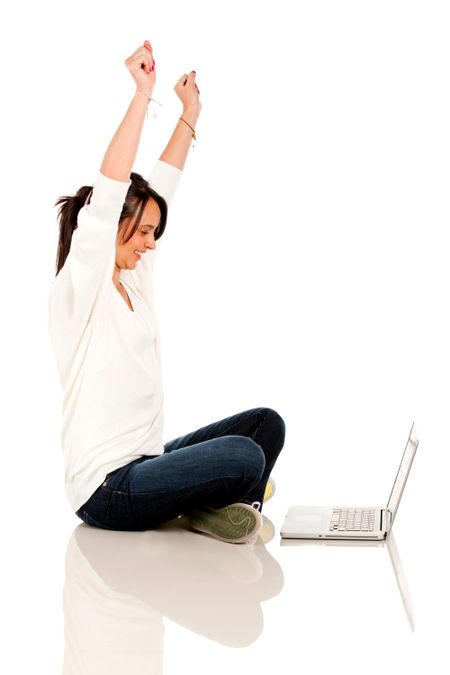 Happy woman with a laptop and arms up? isolated