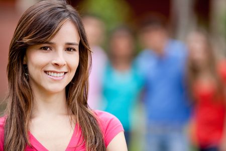 Portrait of a casual woman smiling outdoors