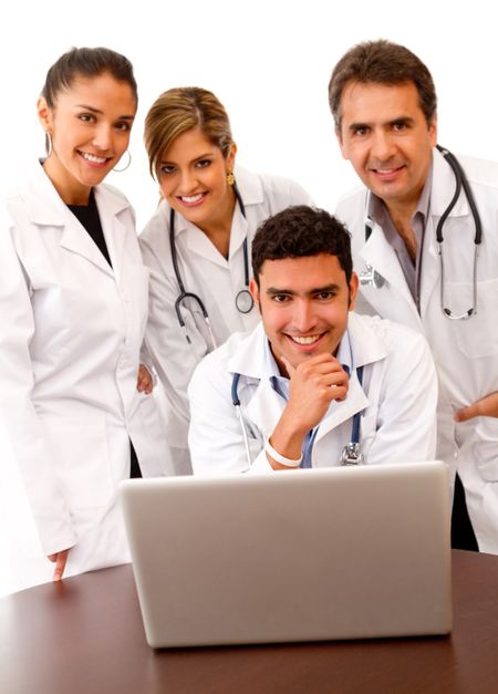 Group of doctors with a laptop ? isolated over white