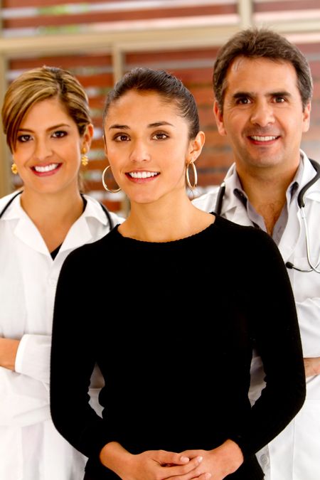 Patient at the hospital with doctors on the background