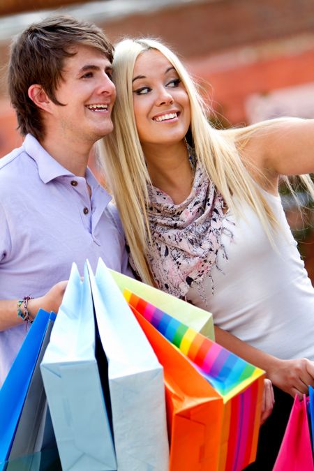 Loving couple at the shopping center with bags