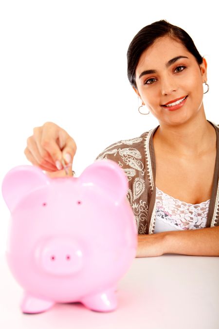 Woman putting her savings in a piggy bank ? isolated