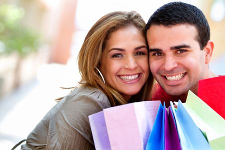 Happy couple at the shopping center with bags
