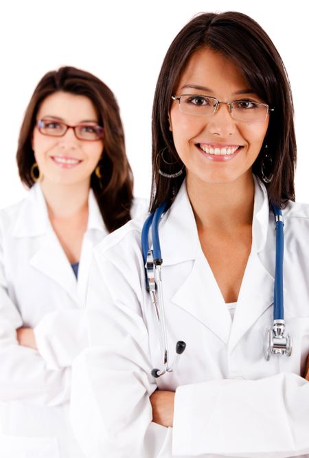 Friendly female doctors smiling - isolated over white
