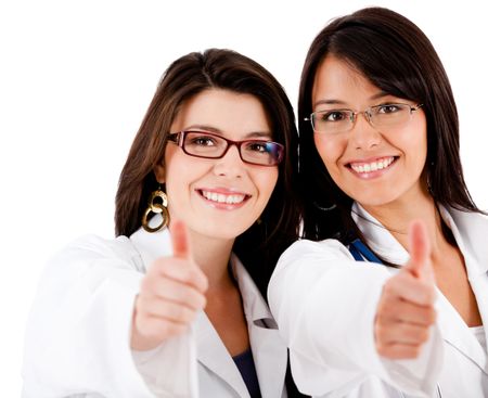 Friendly female doctors with thumbs up - isolated over white