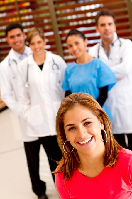 Patient with a group of doctors at the background