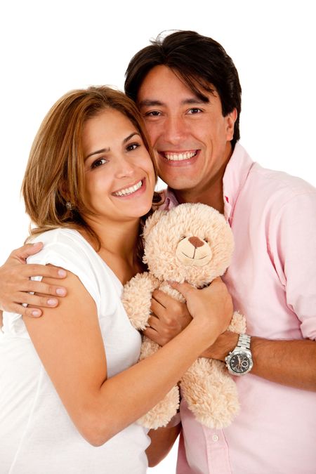 Beautiful loving couple with a teddy bear- isolated over a white background