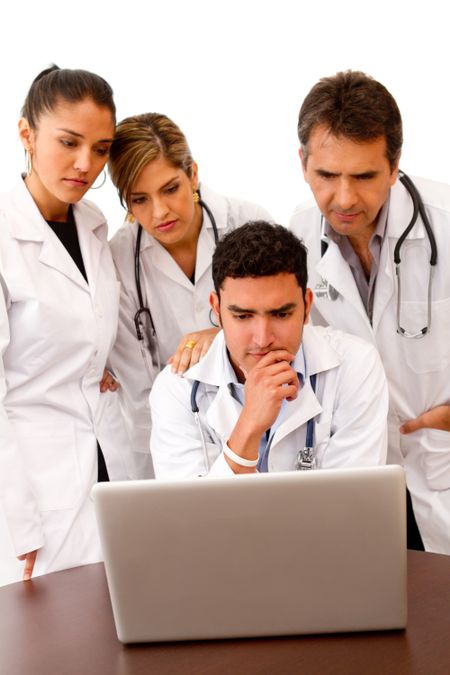 Group of doctors with a computer - isolated over white